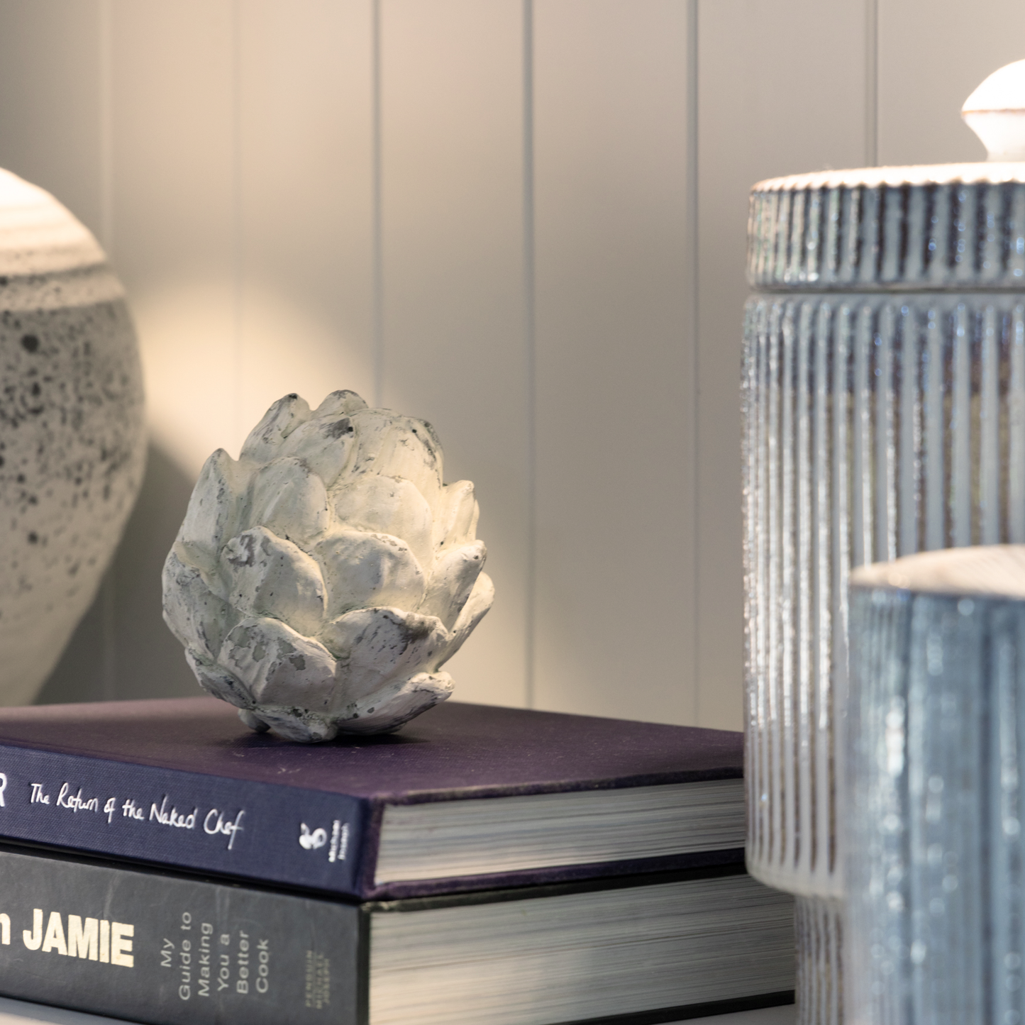 Decorative Artichoke Sculptures arranged on a bookshelf, adding a touch of nature-inspired elegance.