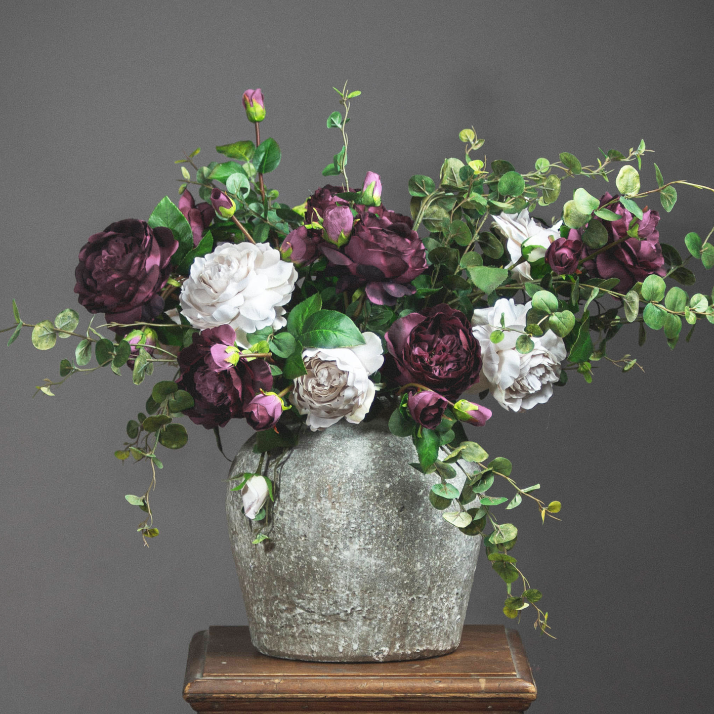 Aged Stone Vase displayed on a wooden shelf, enhancing the rustic interior décor.