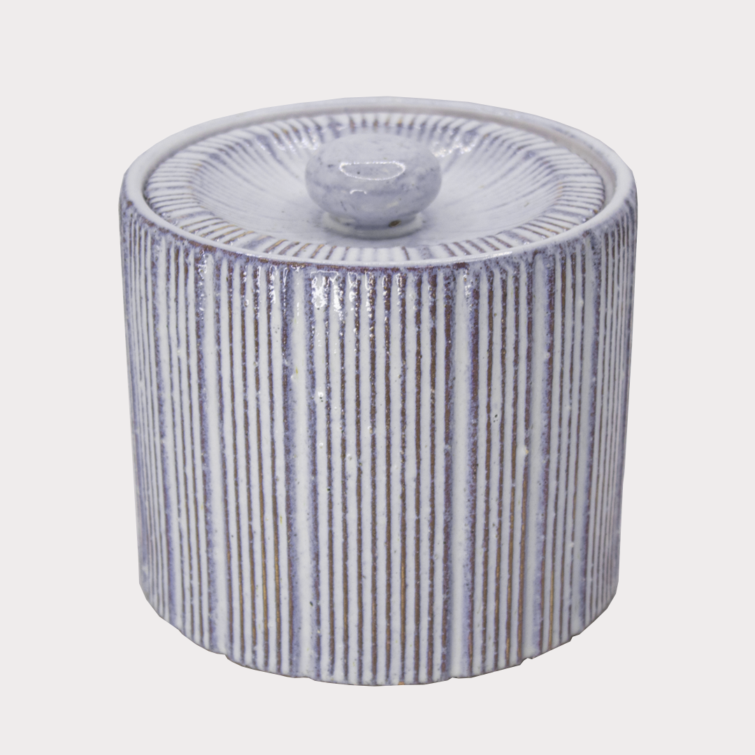Close-up of Small Striped Lidded Jar showcasing its vibrant red and white stripes.