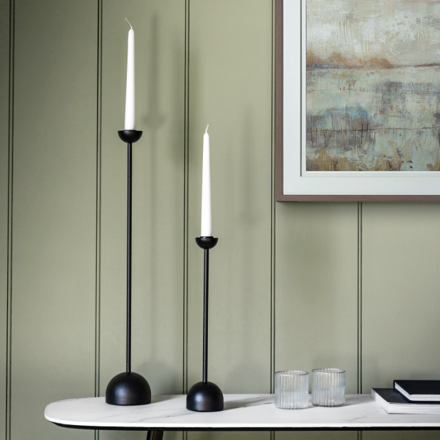 Black iron candlestick with sleek design, available at Clarkson Lee Lifestyle.