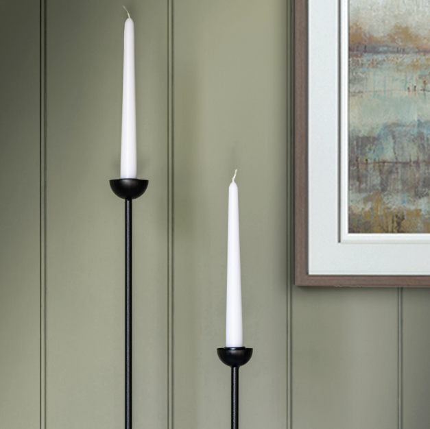 Close-up of small black iron candlestick showcasing its elegant design.