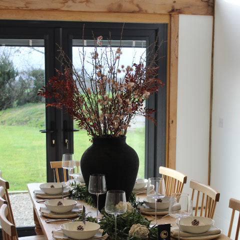 Black Textured Vase displayed in a modern living room setting, enhancing the interior decor.