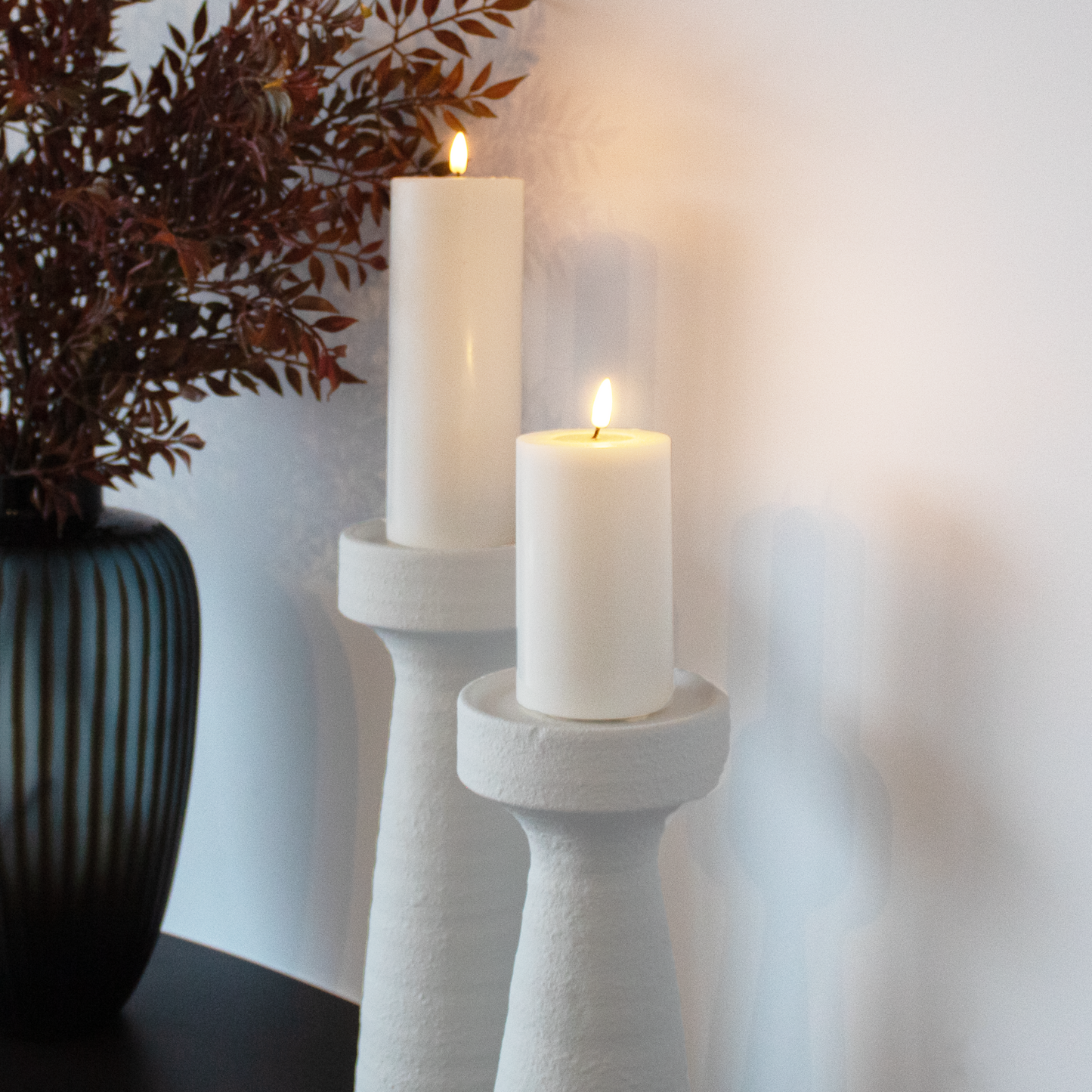 Small and large Plaster Effect Candle Holders displayed together, highlighting size variations.