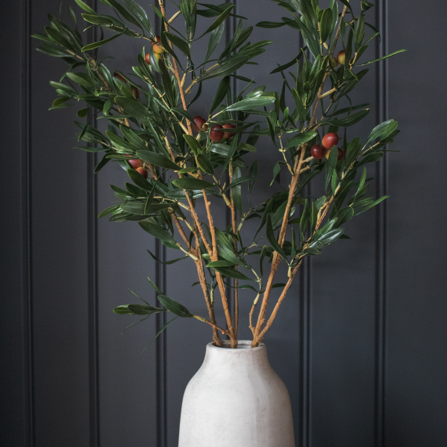 Artificial Olive Branch displayed in a tall vase, adding Mediterranean charm to interior décor.