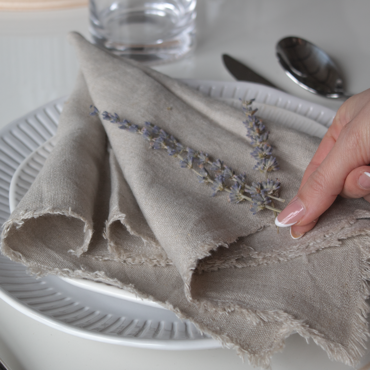 Linen Napkin placed on a dining table, complementing various table settings.