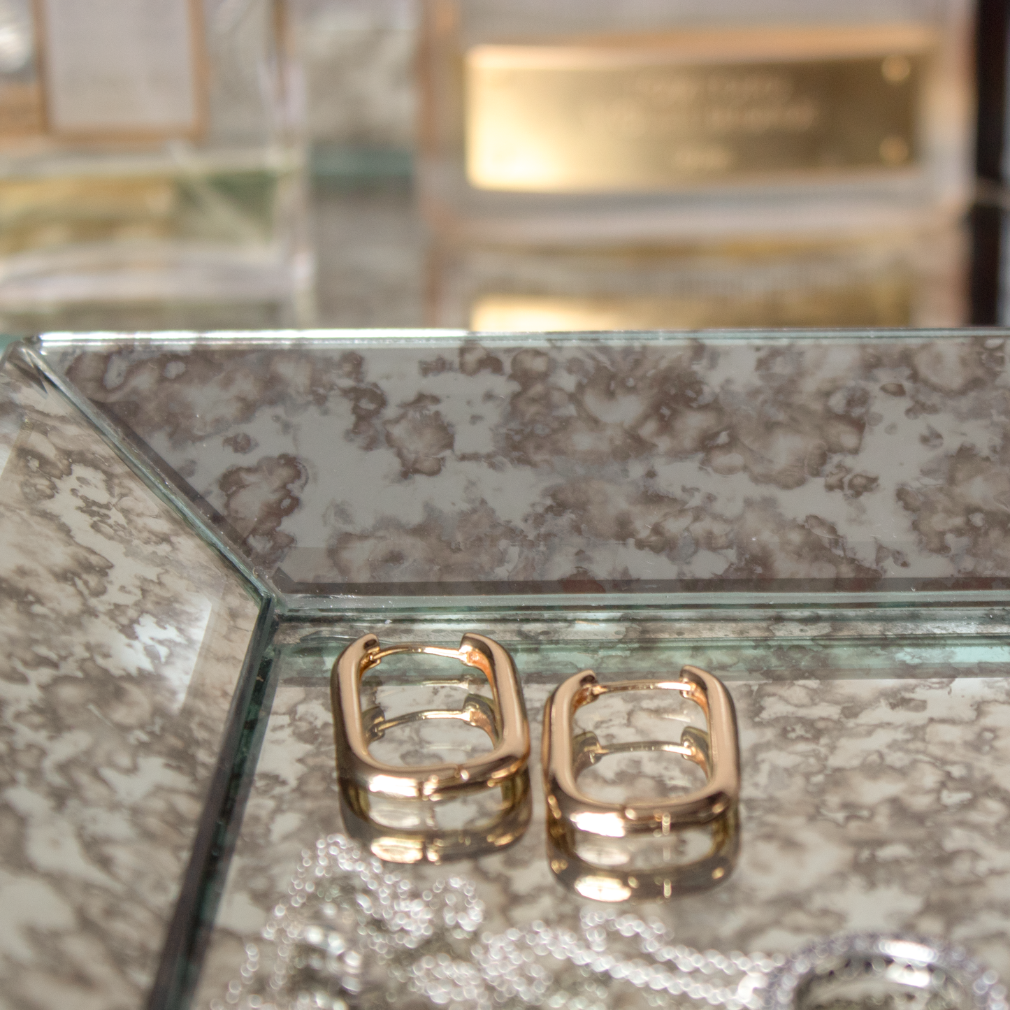 Aged Mirror Tray displayed on a vanity with jewelry.