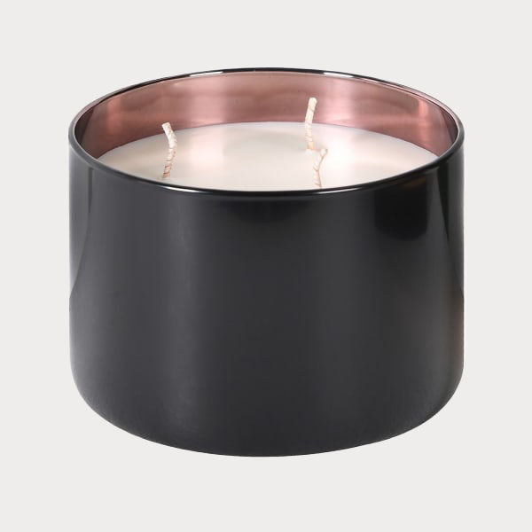 Close-up of Rose Oud candle's black glass jar with lid off, revealing the wax.