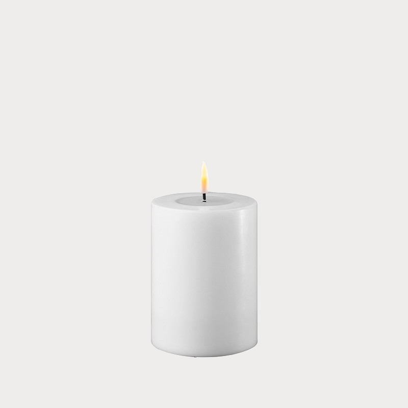 Set of multiple Slim White Indoor LED Candles creating ambient lighting in a dining area.