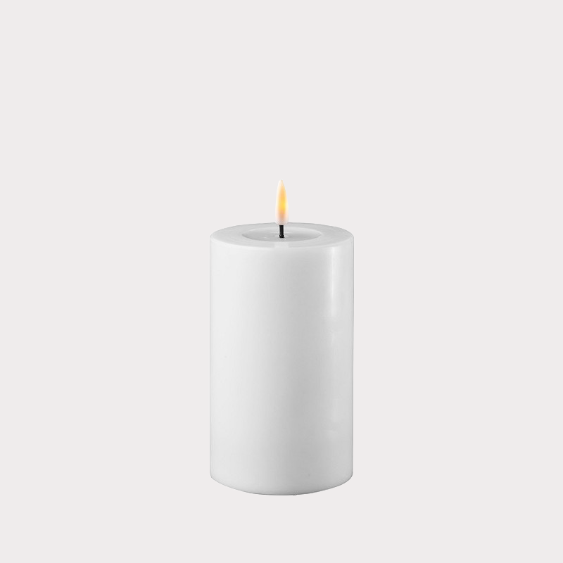 Slim White Indoor LED Candle displayed on a decorative tray with other home accessories.