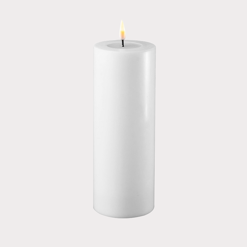 Slim White Indoor LED Candle illuminating a modern living room setting.