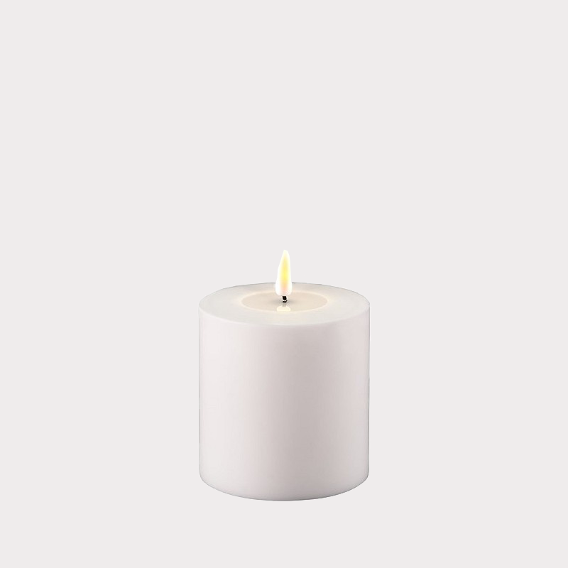 Candles arranged on a mantelpiece.