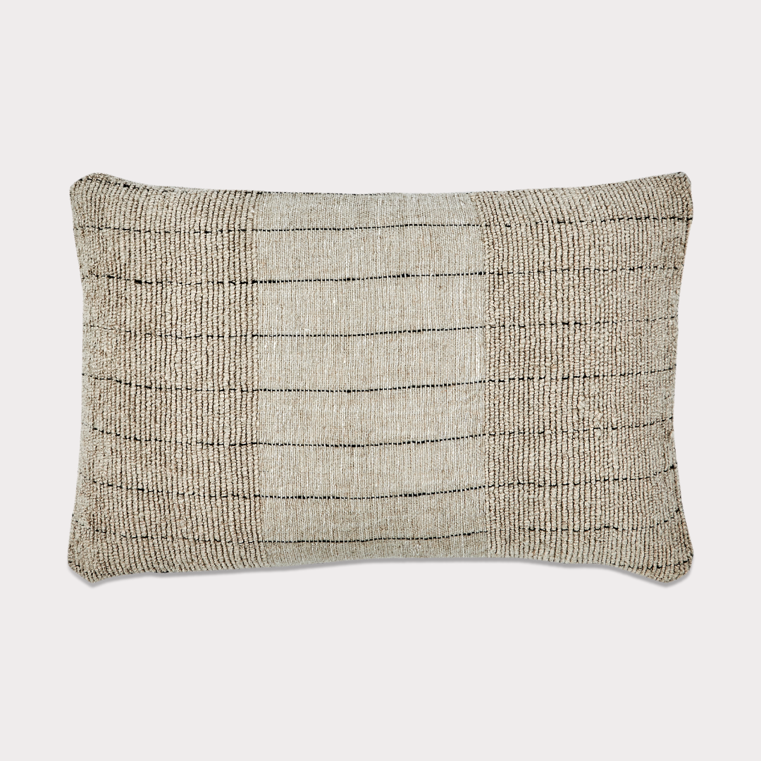 Side view of the cushion highlighting its natural fabric blend and craftsmanship.
