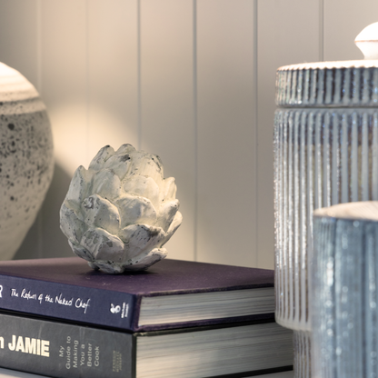 Decorative Artichoke Sculptures arranged on a bookshelf, adding a touch of nature-inspired elegance.