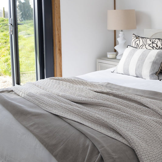 Stonewash Finished Throw in Blue, showcasing its soft texture and subtle color, available at Clarkson Lee Lifestyle.