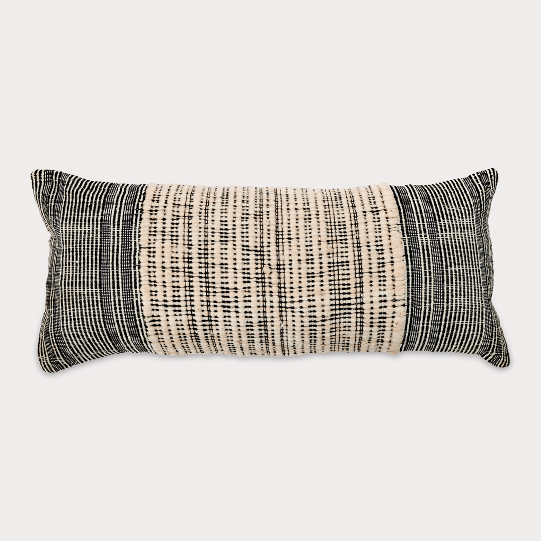 Side view of the cushion highlighting its neutral tones and sustainable craftsmanship.
