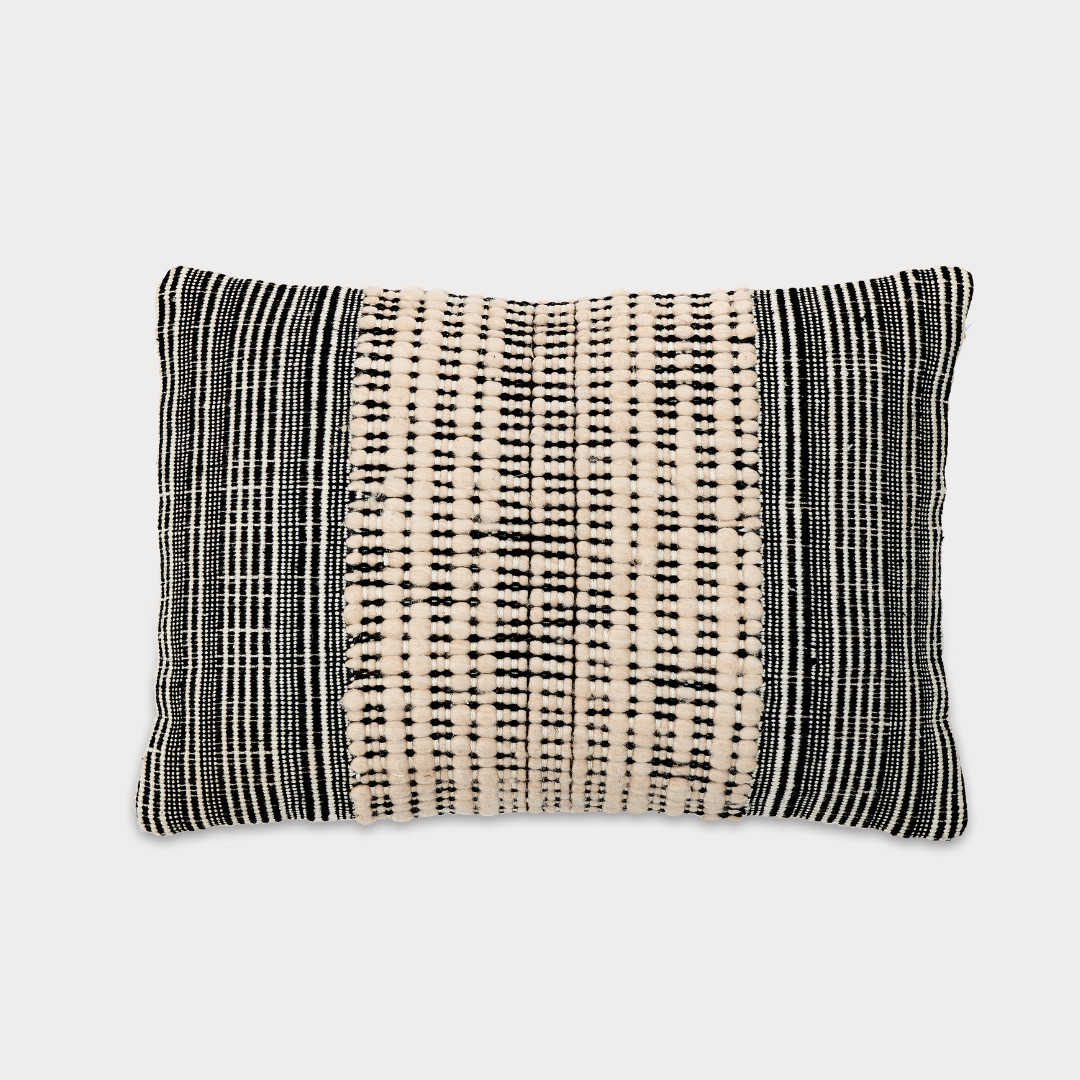 Close-up of the Recycled Black & Neutral Cushion showcasing its textured fabric made from recycled materials.