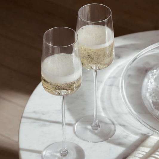 Set of 4 hand-blown champagne flutes, each uniquely crafted, available at Clarkson Lee Lifestyle.