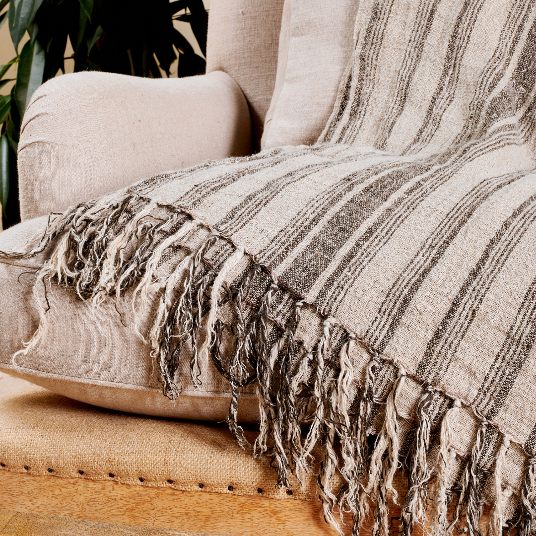 Striped Linen Throw draped over a sofa, adding a touch of elegance to the living room.