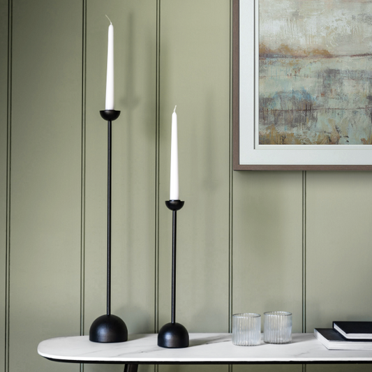 Black iron candlestick with sleek design, available at Clarkson Lee Lifestyle.