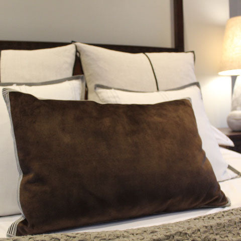 Vintage Velvet Cushion in Brown styled on a modern bed, adding a touch of glamour to the living room.