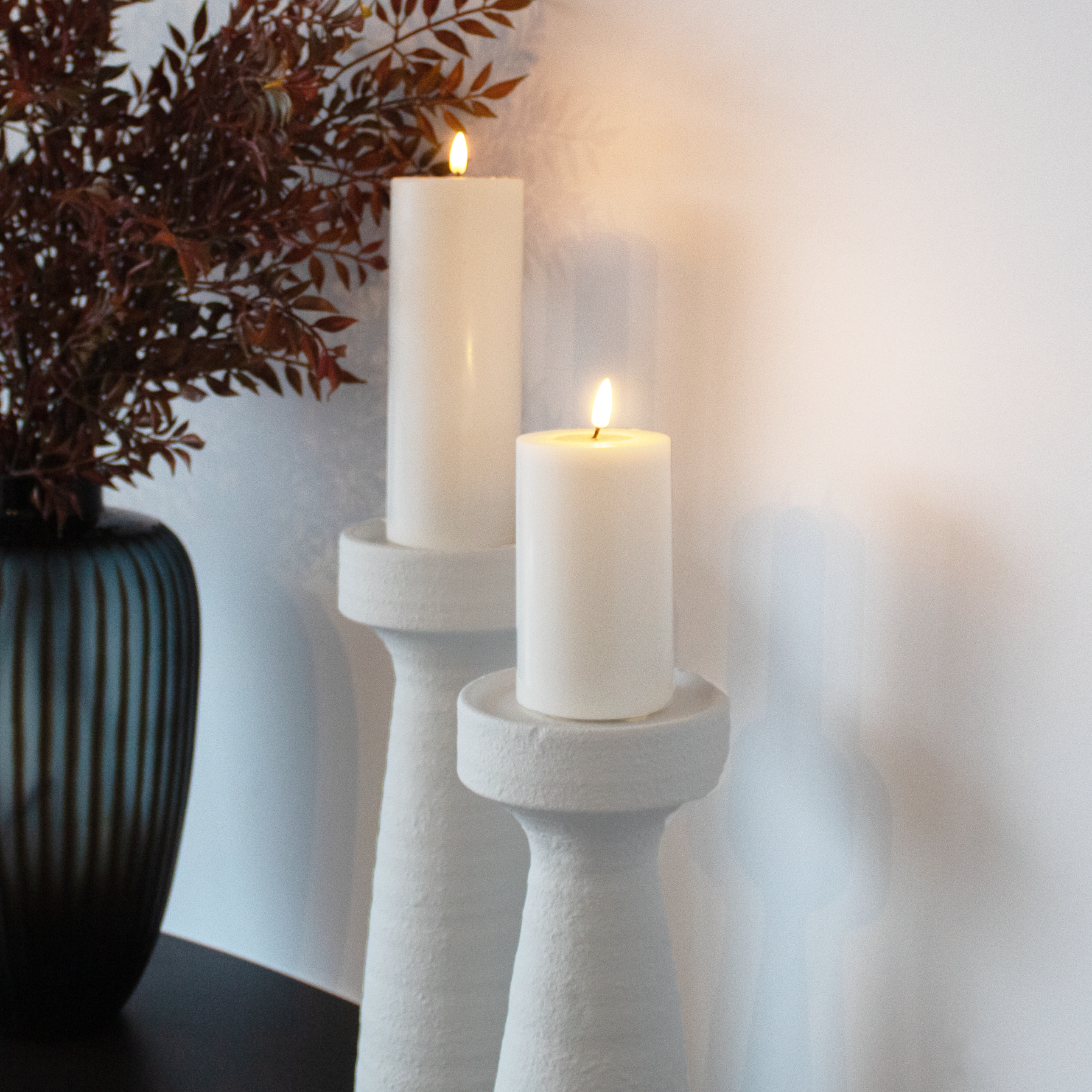 Small and large Plaster Effect Candle Holders displayed together, highlighting size variations.
