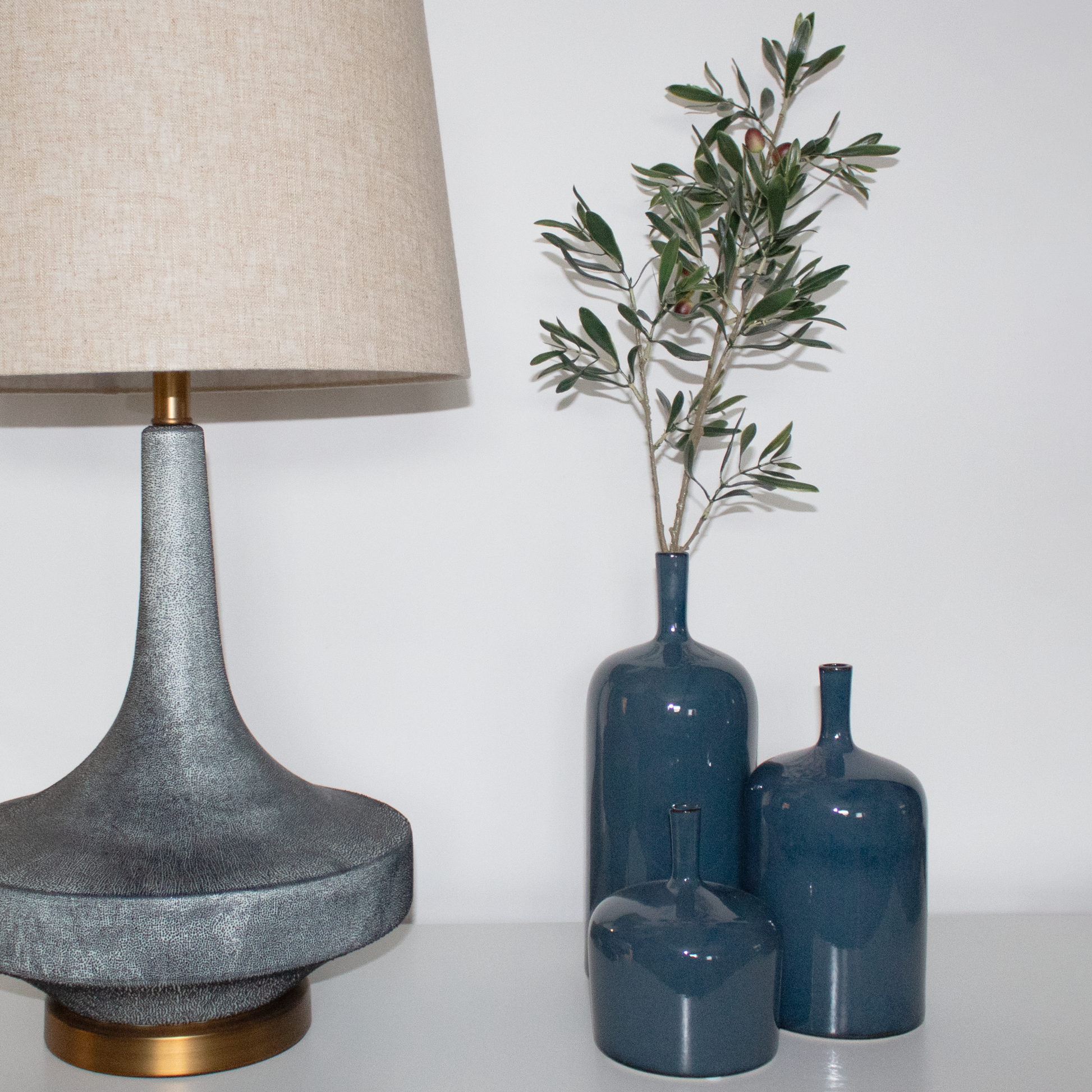Set of three Scandinavian-style vases in varying sizes and neutral tones.