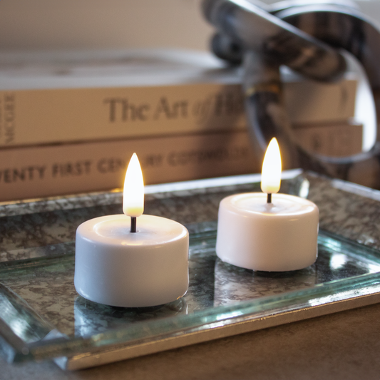 Set of 2 White LED Tealights emitting warm glow, flameless candles by Clarkson Lee Lifestyle.
