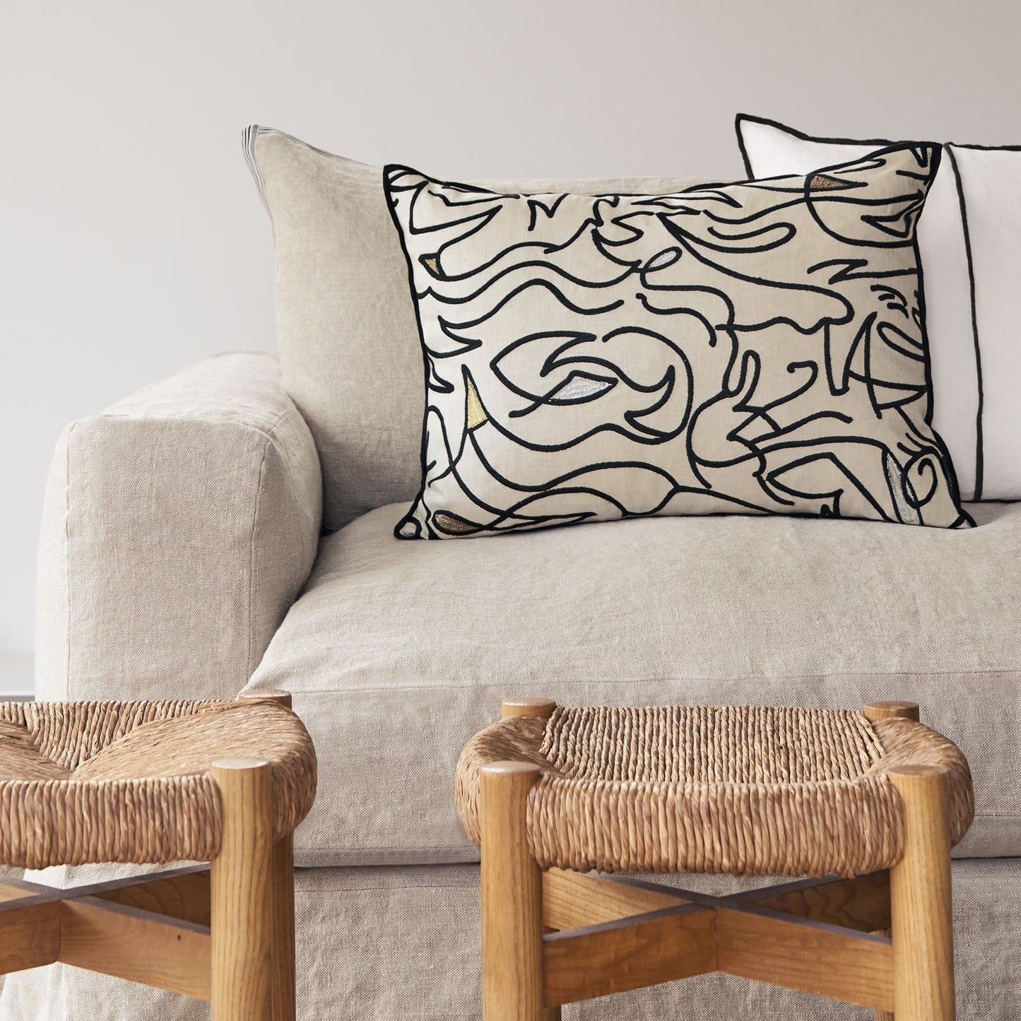 Close-up of Embroidered Cushion showcasing the intricate 'Swirls' pattern.