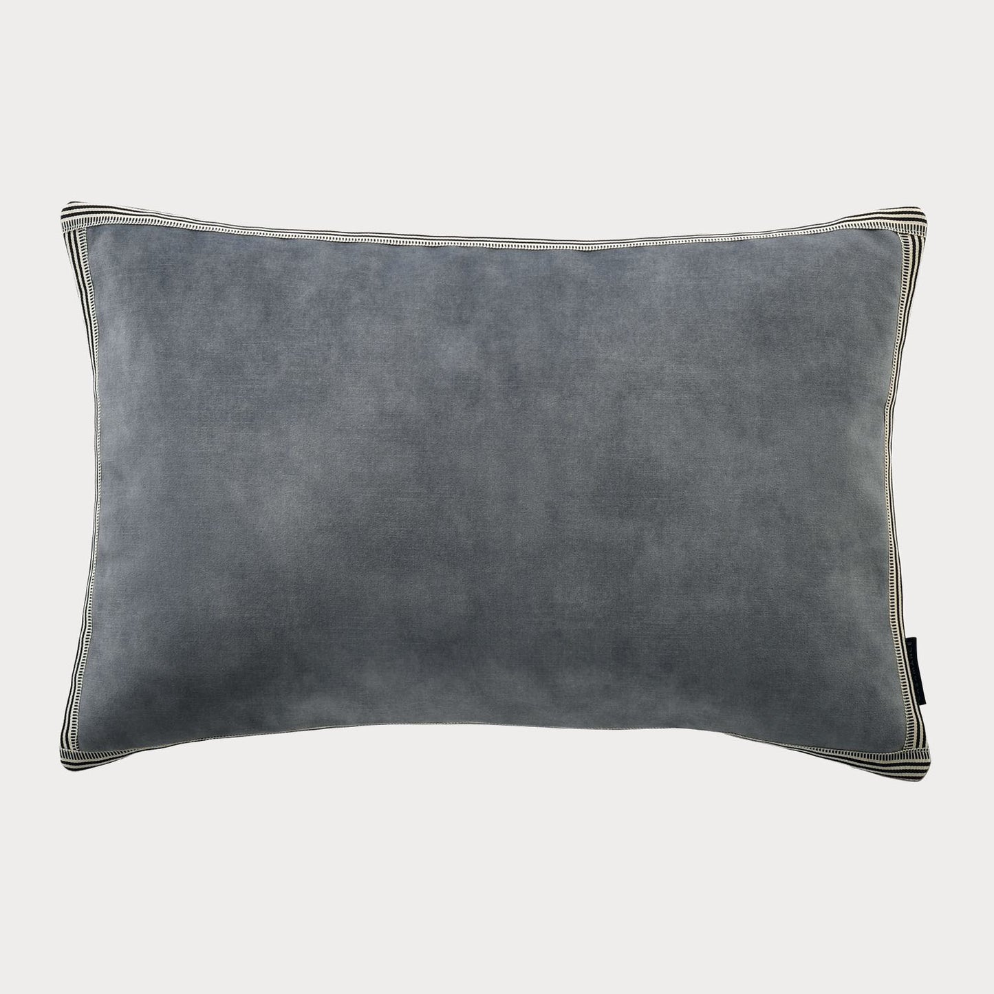 Side view of the blue cushion highlighting its plush velvet fabric and rich colour.