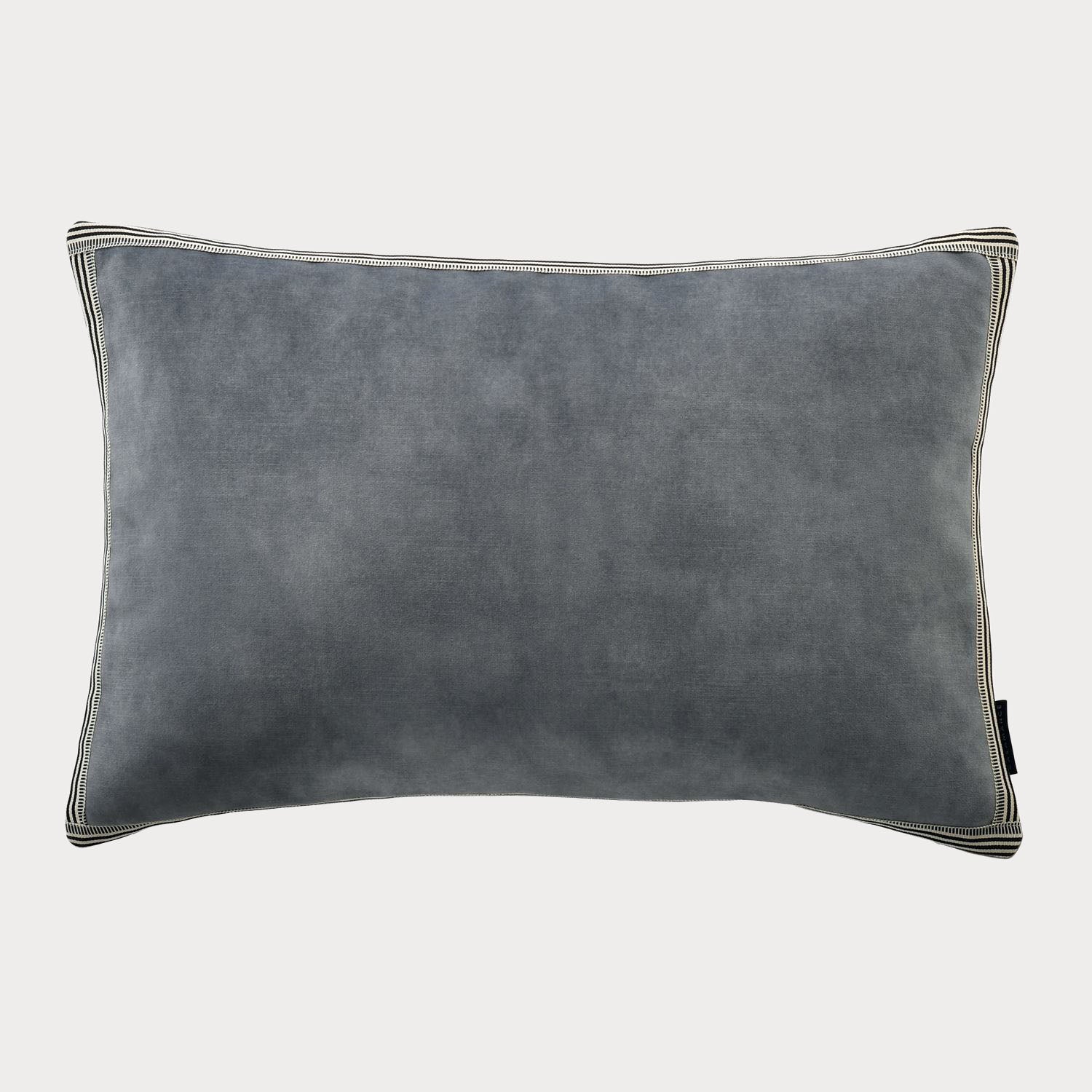 Side view of the blue cushion highlighting its plush velvet fabric and rich colour.