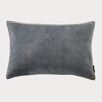 Side view of the blue cushion highlighting its plush velvet fabric and rich colour.