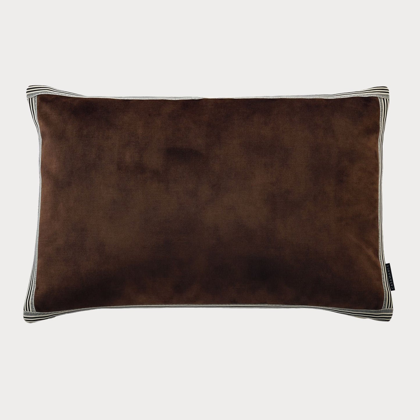Side view of the brown cushion highlighting its plush velvet fabric and rich colour.