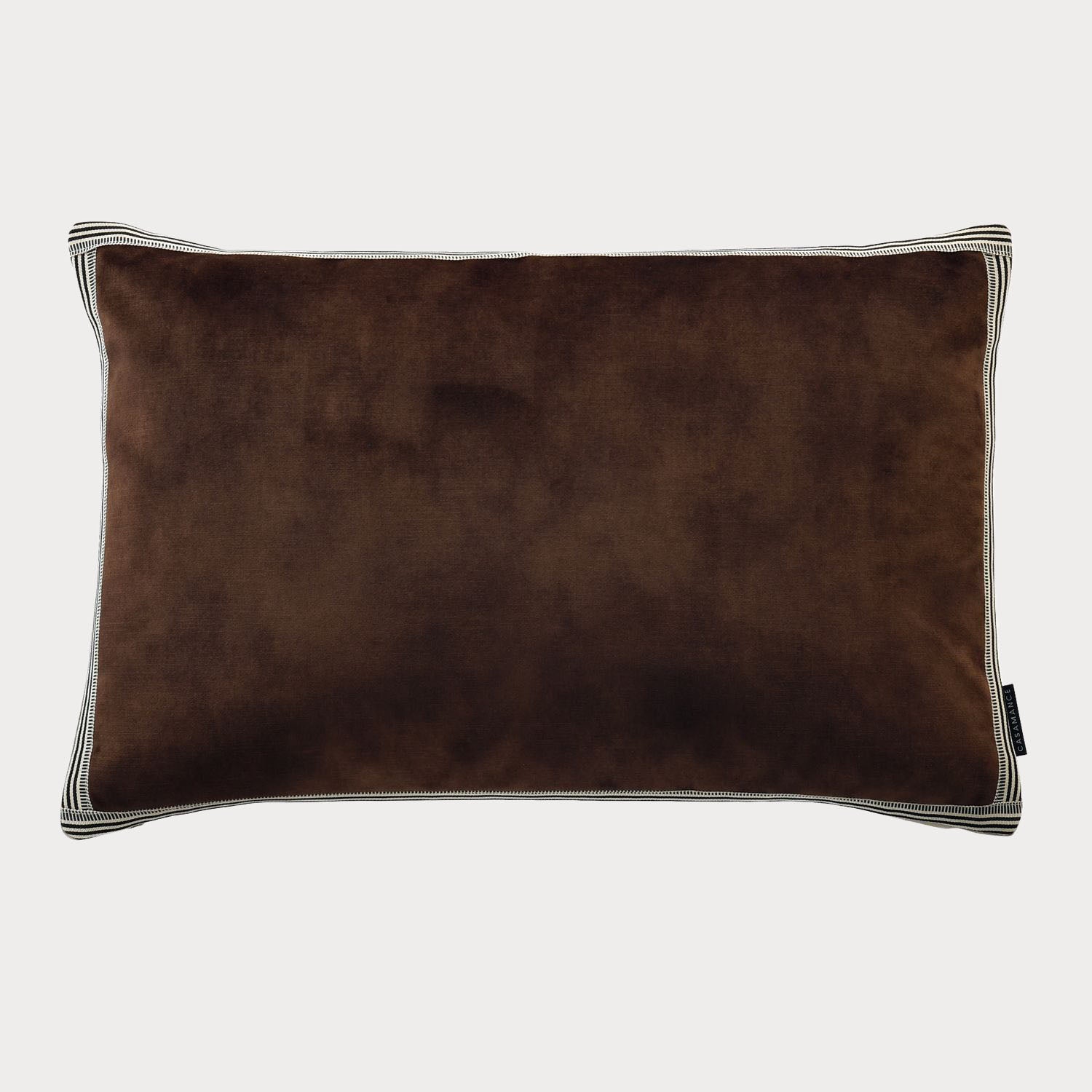Side view of the brown cushion highlighting its plush velvet fabric and rich colour.