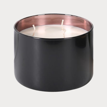 Close-up of Rose Oud candle's black glass jar with lid off, revealing the wax.