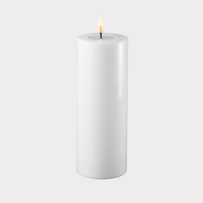 Slim White Indoor LED Candle illuminating a modern living room setting.