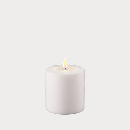 Candles arranged on a mantelpiece.