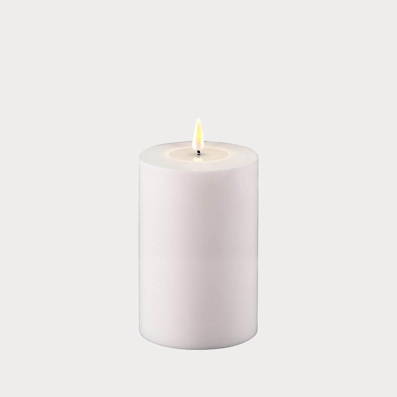 Indoor & Outdoor LED Candle placed on a patio table, illuminating an evening gathering.