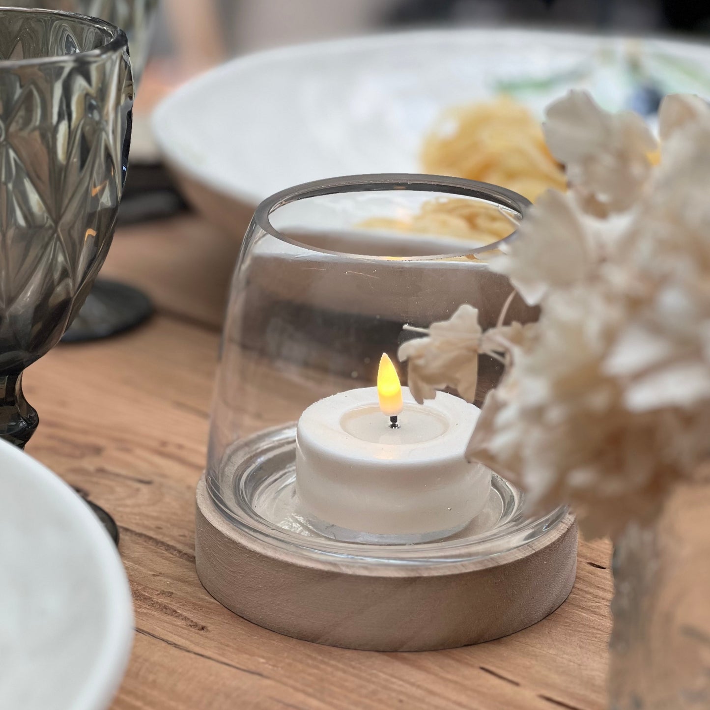 Close-up of White LED Tealight showcasing realistic flame effect.